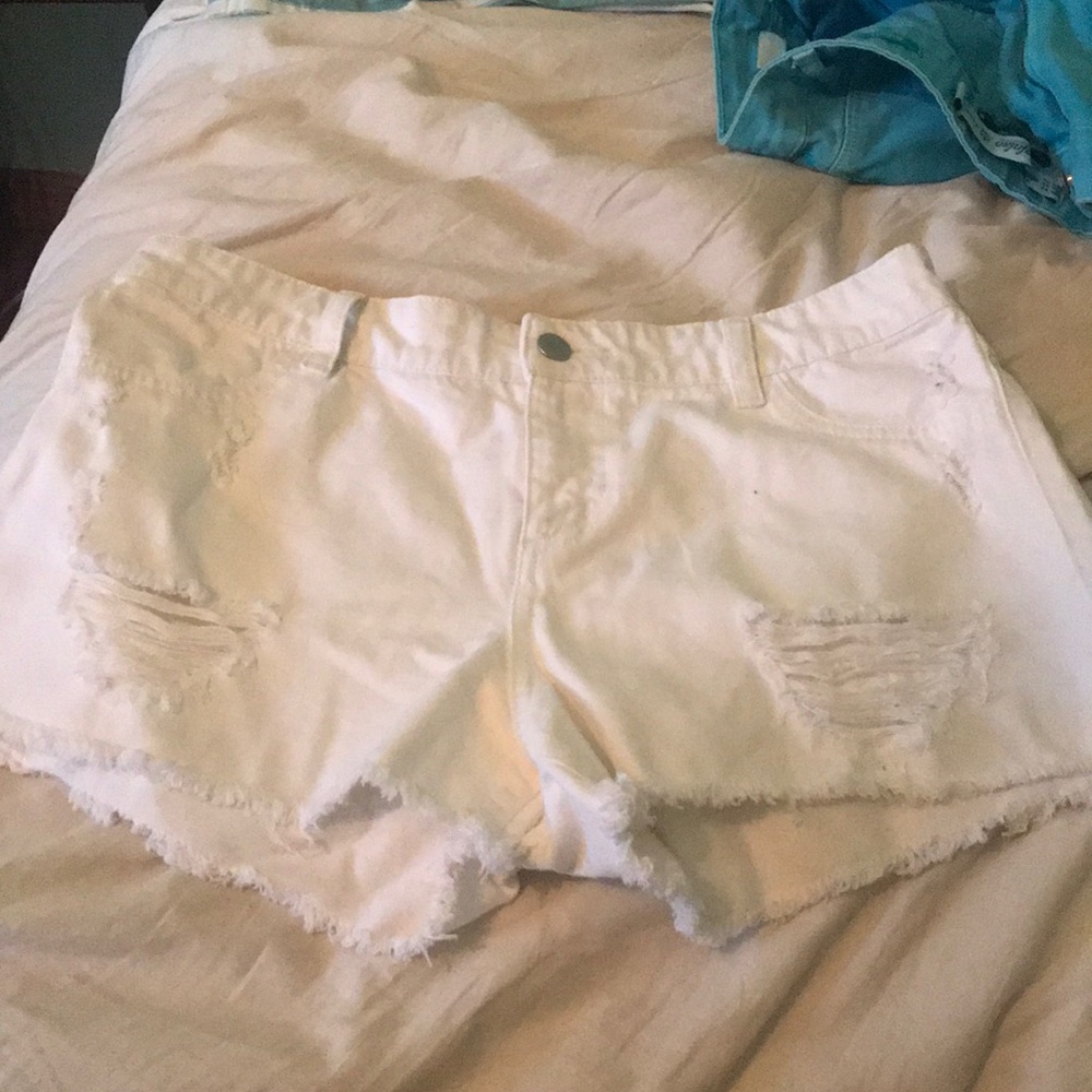 Distressed white denim shorts.